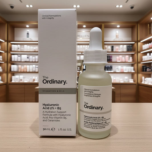 The Ordinary skincare serum bottle and packaging on a textured surface